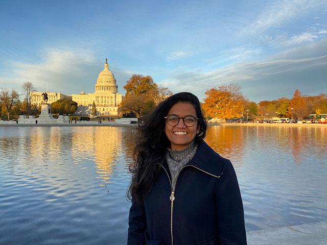 Aparna in front of the Capitol building